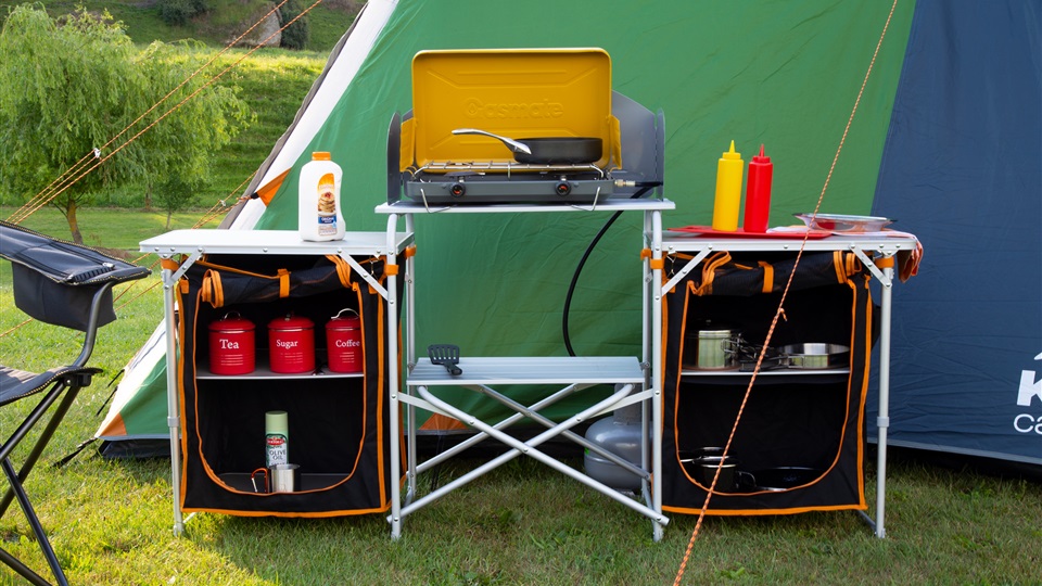 The Kiwi Camping Kitchen & Cupboards has a cooker area in the middle with prep space and cupboards on each side.